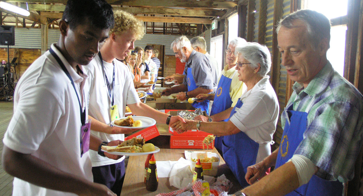 Rotary volunteers handing out food the students