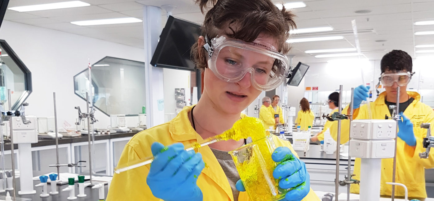 Science student observing yellow goo