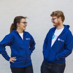 Female and male showcasing blue jacket