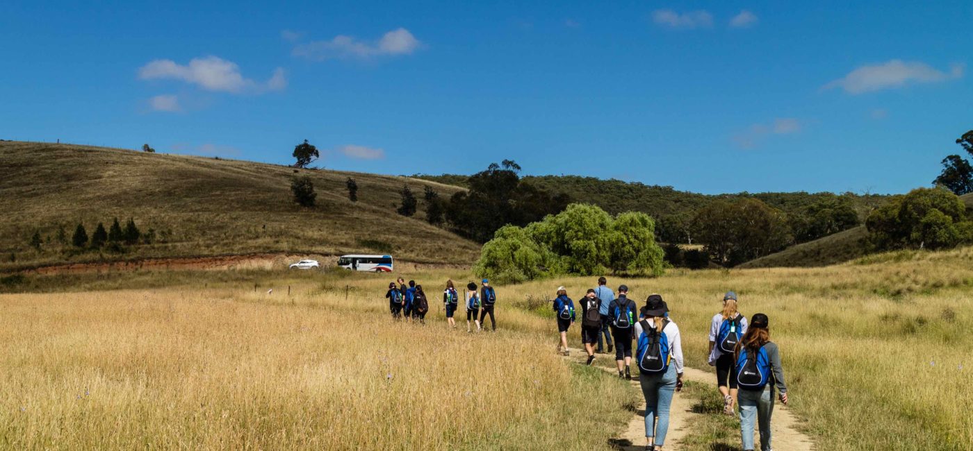 Students walking in a field