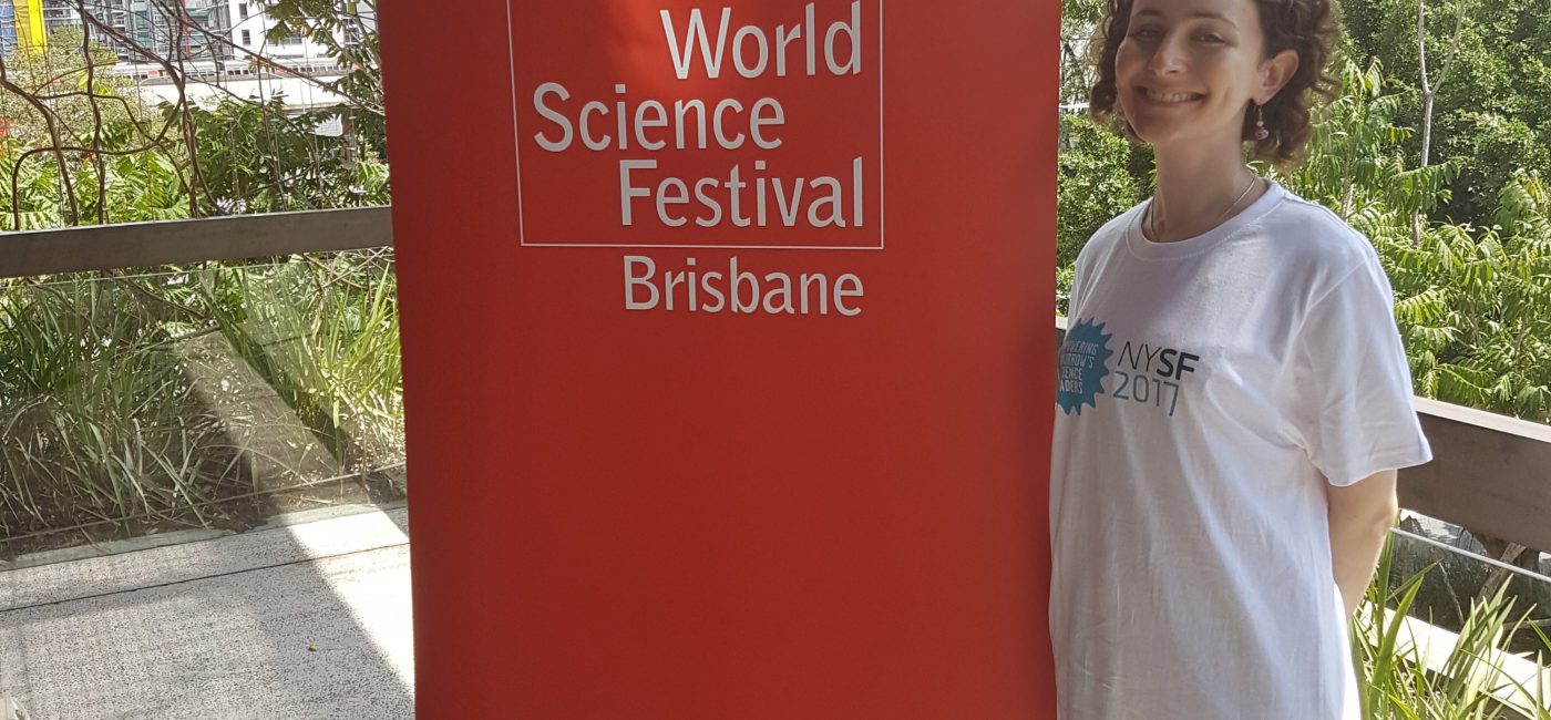 Lady standing next to a 'World Science Festival' banner in Brisbane