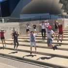 2021 NYSF Year 12 Participants are jumping into the air on the stairs in front of the John Curtin School of Medical Research